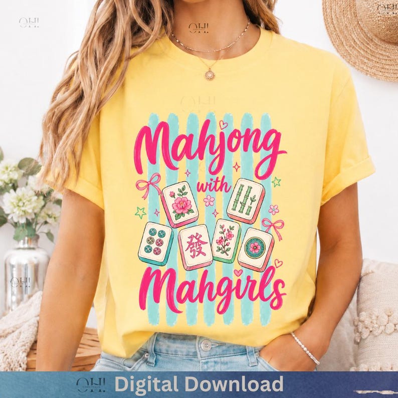 May include: Yellow t-shirt with the text "Mahjong with Mahgirls" in pink, featuring illustrations of Mahjong tiles. The design includes blue vertical stripes and decorative elements like stars and flowers. "Digital Download" is printed at the bottom.
