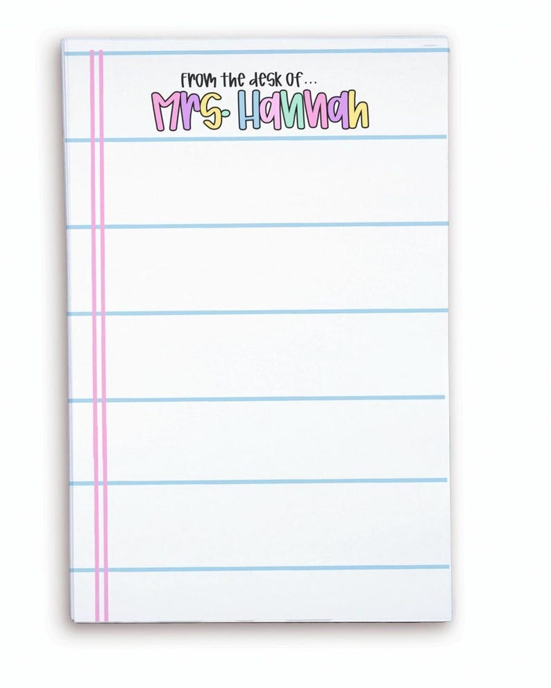 May include: White notepad with blue horizontal lines and pink vertical lines on the left side. The text "from the desk of... MRS HANNAH" is printed at the top in colorful bubble letters. The notepad is rectangular.