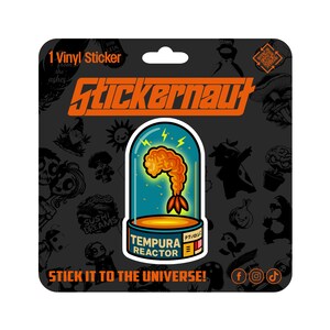 May include: A vinyl sticker with a cartoon shrimp in a glass container, labelled "TEMPURA REACTOR" and "STICK IT TO THE UNIVERSE!". The sticker has a black background with various cartoon illustrations.