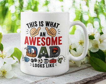 May include: A white ceramic mug featuring the text "THIS IS WHAT AN AWESOME DAD LOOKS LIKE" in black and red. The design includes illustrations of a tool belt, mountains, a grill, a mug, a dumbbell, a soccer ball, a toolbox, and a fish.