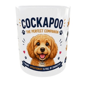 May include: A white ceramic mug featuring a cartoon illustration of a golden-brown Cockapoo puppy. The text reads COCKAPOO THE PERFECT COMPANION and SMART, AFFECTIONATE & FULL OF CHARACTER, surrounded by small paw prints, hearts, and dog-related icons.