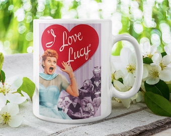 May include: White ceramic mug with a colorful image of Lucille Ball from the "I Love Lucy" television show. The mug has a red heart with the text "I Love Lucy" on it.