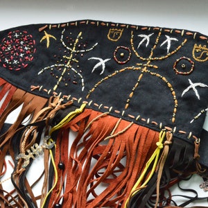 Shaman mask with embroidered masks helpers and fringe. Made of black linen with embroidery brown and gold, brown leather fringe, beads.