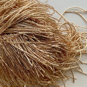 Pale gold curly cannetille, very shiny. French cannetille allows you to add relief and light to your embroidery.