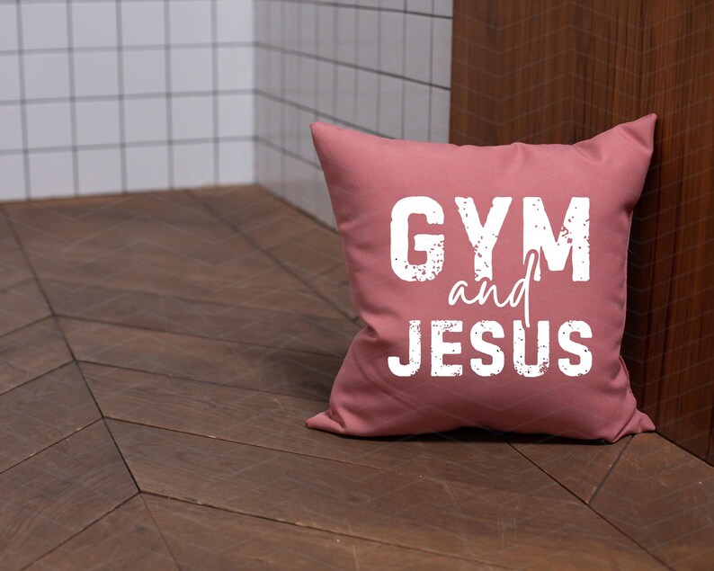 May include: A pink throw pillow with the text "GYM and JESUS" in white lettering.