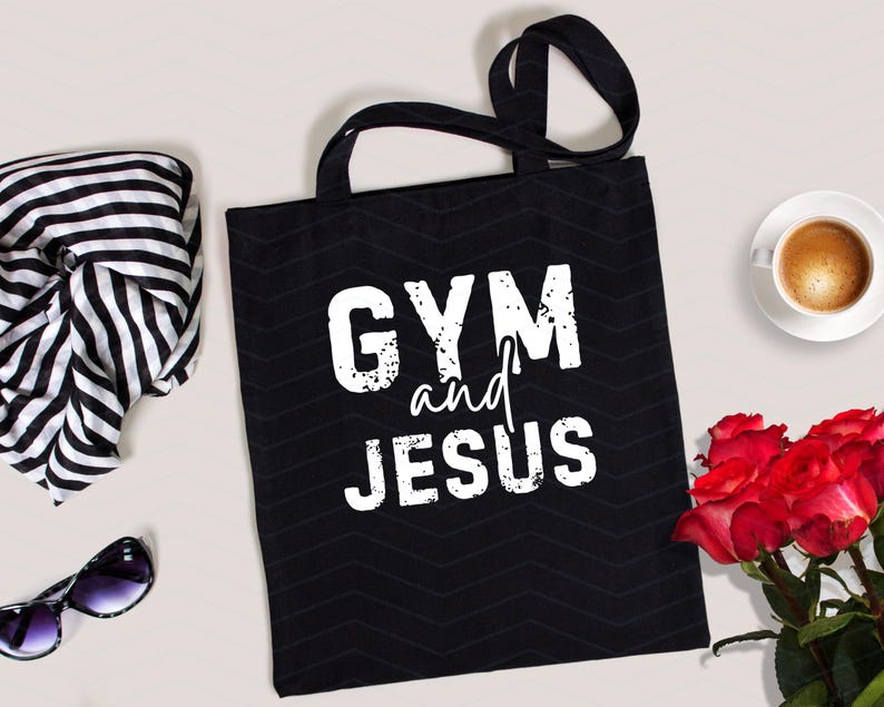 May include: Black canvas tote bag with white text that reads "GYM and JESUS".