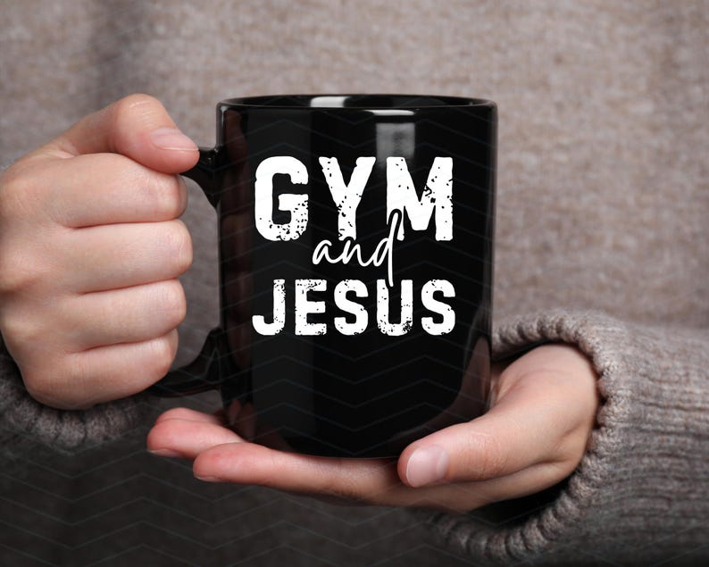 May include: Black coffee mug with white text that reads "GYM and JESUS".