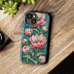 May include: A teal phone case with a floral design. The flowers are pink and white with gold accents. The case has a camera cutout.