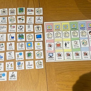 May include: A visual schedule for children with colourful squares containing images and text. The schedule includes activities like school, home, play dates, and sports. The days of the week are listed across the top.