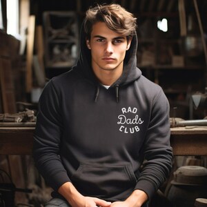 May include: A black hooded sweatshirt with the text "Rad Dads Club" in white lettering.