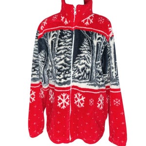 May include: A red and white fleece jacket with a winter forest scene and snowflake pattern. The jacket has a high collar, a full-length zipper, and a black, white, and gray forest design across the chest.