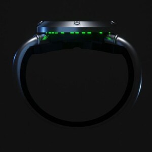 May include: A black wristwatch with a green digital display. The watch is designed with a circular face and a band that wraps around the wrist.