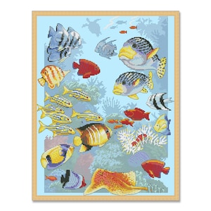 May include: A colorful cross-stitch pattern depicting a variety of fish swimming in a blue ocean. The fish are in various colors, including red, orange, yellow, green, blue, and purple. There are also some coral reefs and other sea life in the pattern.