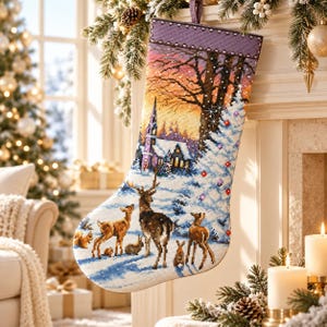 May include: A Christmas stocking featuring a detailed cross-stitch design of a winter forest scene. The image depicts a deer, two fawns, and small woodland animals in snow, with a church and trees in the background under a sunset sky.