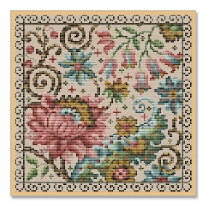 May include: A square cross-stitch floral design featuring a large pink flower, blue and yellow flowers, and green leaves. The design is framed by a decorative border and set against a beige background. The needlework showcases a detailed, colorful botanical pattern.