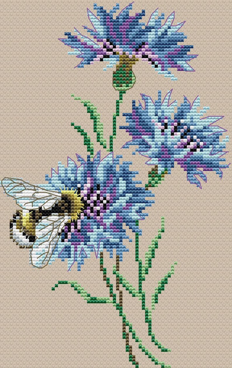 May include: Cross-stitch design of blue and purple flowers with green stems and leaves. A bee is positioned on one of the flowers. The background is a solid tan color. The flowers are in full bloom.