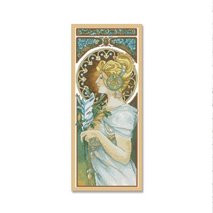 May include: A cross-stitch pattern featuring a woman in a white dress holding a bouquet of flowers. The woman has blonde hair and is wearing a decorative headpiece. The background is a stylized art nouveau design with floral motifs.