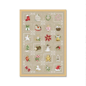 May include: A beige background with a brown frame surrounding a white and beige cross-stitch design. The design is a Christmas advent calendar with 24 squares, each containing a different Christmas-themed image. The numbers 1 through 24 are printed in black on the squares.