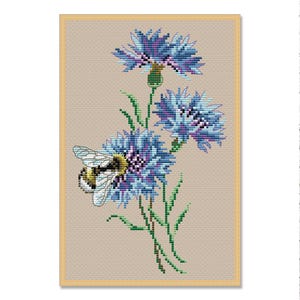 May include: Cross-stitch pattern of blue cornflowers with green stems and leaves, and a bee. The flowers have a detailed, textured appearance, with shades of blue and purple. The bee is yellow and black, with translucent wings. The background is a light tan.