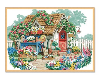 May include: A cross-stitch pattern featuring a charming cottage with a red door and a sign that reads "Enter Friend". The cottage is surrounded by a white picket fence and lush greenery, including flowers in various colors.