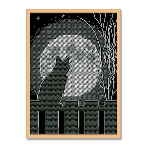 May include: A diamond painting kit featuring a black silhouette of a cat sitting on a fence against a large, textured white full moon. The scene includes a bare white tree branch on the right side, all set against a dark black background.