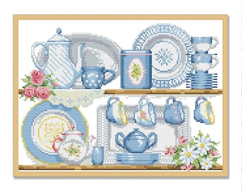 May include: Cross-stitch artwork featuring a collection of blue and white teacups, teapots, and plates arranged on shelves. The design includes floral accents and a framed wooden border. The color palette is primarily blue and white with touches of pink and yellow.