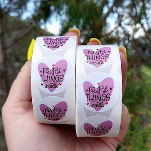 May include: Roll of pink and white round stickers with the text "Pretty Things Inside" in a heart shape.