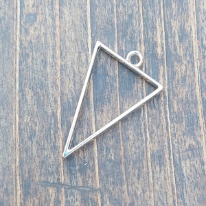 May include: Silver triangle pendant with a loop at the top for hanging.
