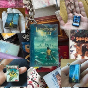 May include: A collection of miniature book keychains featuring various cover art designs, including The Lightning Thief, Brooklyn, Berserk, and The Nightingale. Each small book replica is attached to a silver-toned metal keyring and chain.