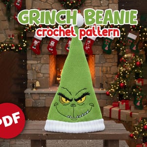 May include: A green Grinch beanie crochet pattern. The hat features the Grinch's face embroidered on the front, with a white brim and a white pom-pom on top. The text "GRINCH BEANIE crochet pattern" is displayed above the hat.