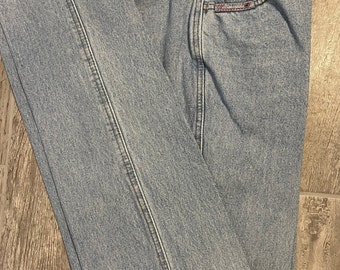 May include: Light blue denim jeans with a single back pocket and a small label that reads "Z Cavaricci" in white lettering.