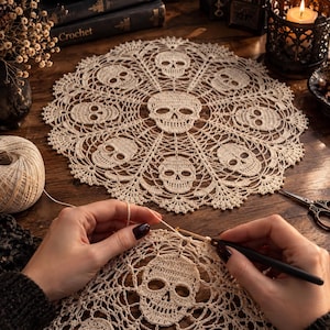 May include: A round, off-white crochet doily featuring a repeating pattern of skulls arranged in a circular design. The intricate lace work includes a central skull surrounded by eight smaller skulls, all connected by delicate, web-like stitching.