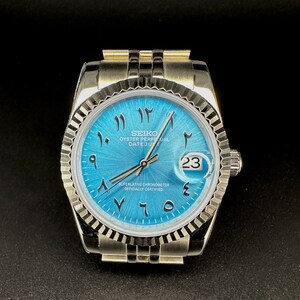 Custom 40mm Seiko Stainless steel Watch. Blue Sun Burst Dial with Arabic Numbers with steel bracelet.