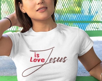 May include: White t-shirt with a brown and red graphic that says "Jesus is Love".