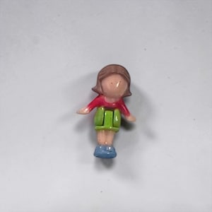 May include: A white ceramic mug with a black handle and the text "But First, Coffee" in a bold, black font. The mug is sitting on a wooden surface. The mug is 4 inches tall.