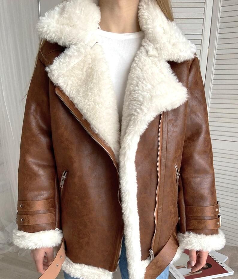 B3 bomber shearling jacket, women’s RAF aviator coat, vintage brown lambskin leather, distressed pilot bomber jacket, fur collar and cuffs coat, winter sheepskin outerwear women, handmade leather bomber coat, retro flight jacket for women, WWII pilot style shearling, warm winter aviator jacket, classic lambskin bomber, brown sheepskin winter coat, women’s distressed leather jacket, RAF bomber with fur trim, stylish flight bomber coat, real shearling pilot jacket, vintage warm leather coat