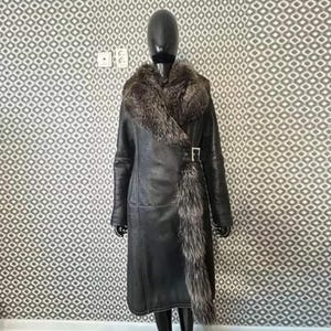 May include: A long black leather coat with a large fur collar and a fur trim down the front. The fur is a mix of grey and white.