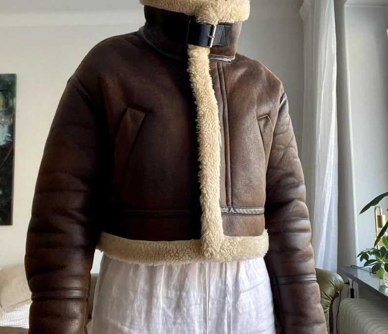 women's sheepskin jacket, brown aviator jacket, B3 bomber jacket, vintage leather jacket, distressed sheepskin bomber, lambskin winter coat, shearling leather jacket, fur collar jacket, winter bomber jacket, real leather bomber, women's flight jacket, warm shearling coat, classic aviator style, cozy winter outerwear, retro bomber jacket, women's vintage coat, shearling jacket for her, leather coat with fur cuffs, WWII pilot jacket, brown lambskin bomber, winter coat gift idea