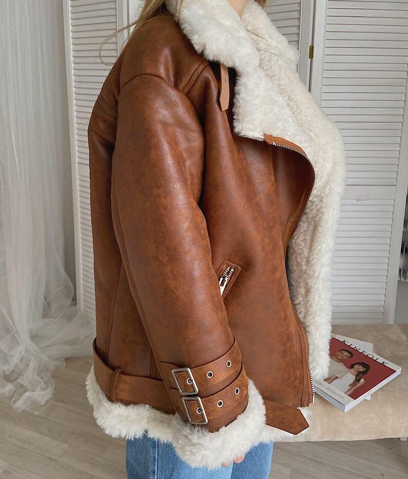 women’s brown bomber jacket, shearling lambskin aviator coat, distressed leather winter jacket, vintage RAF flight bomber, fur-lined collar coat women, B3 pilot style bomber jacket, warm sheepskin leather outerwear, WWII inspired winter coat, retro lambskin shearling bomber, women’s classic RAF jacket, soft fur collar leather coat, vintage flight style bomber, handmade distressed leather jacket, cozy winter pilot coat, brown winter leather bomber, real sheepskin flying coat for women