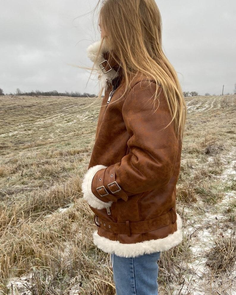 vintage sheepskin B3 jacket, RAF style pilot coat women, distressed lambskin shearling jacket, winter leather bomber with fur, brown aviator flight jacket, real shearling collar coat, WWII bomber style jacket, warm winter coat for her, leather pilot jacket women, handmade lambskin outerwear, vintage flight bomber women, brown fur-lined coat, soft leather winter jacket, stylish aviator bomber coat, women’s retro RAF jacket, B3 fur trim bomber coat, cozy winter lambskin shearling jacket