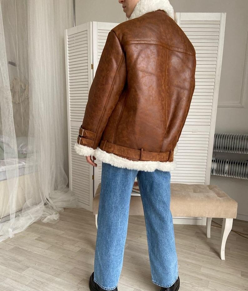 shearling bomber jacket, women’s distressed aviator coat, vintage lambskin winter jacket, B3 flight bomber women, RAF style pilot coat, fur collar winter outerwear, warm sheepskin jacket for her, handmade lambskin bomber, real leather flight jacket, WWII inspired women’s bomber, classic brown shearling coat, cozy pilot style jacket, fur-lined cuffs leather coat, brown winter bomber jacket, women’s warm aviator outerwear, timeless shearling leather coat, vintage pilot jacket women