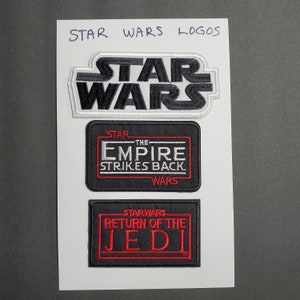 May include: Three embroidered patches featuring the Star Wars logo, The Empire Strikes Back logo, and Return of the Jedi logo. The patches are black with white and red embroidery.
