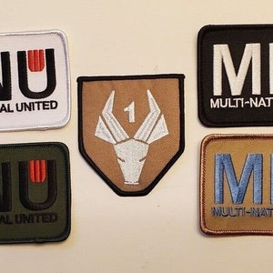 May include: Five embroidered patches with the acronym "MNU" for "Multi-National United". One patch features a white animal head with the number "1" above it. The patches are on a white background.