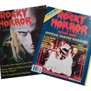 May include: Two issues of the Rocky Horror Picture Show official poster magazine. The first issue features a photo of a man with long blonde hair and a black and white photo of a man in a white shirt and black trousers. The second issue features a photo of the cast of the Rocky Horror Picture Show in costume. The text on the cover of the first issue reads "Rocky Horror Official Poster Magazine". The text on the cover of the second issue reads "The Rocky Horror Picture Show Official Poster Magazine".