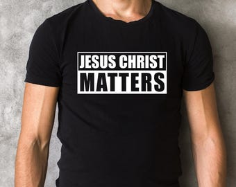 May include: A black t-shirt with white text that reads "JESUS CHRIST MATTERS" in a bold, rectangular box.