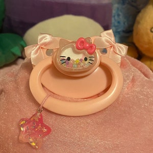 Adult Pacifier -Hello Kitty Shaker with Star Charm- Pink Paci with Bows (Glow-in-the-dark centerpiece)