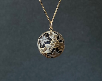 Japanese temari ball pendant with geometric design, on long chain necklace. Silk embroidery. Colors: gray/blue/red/green.