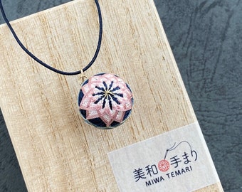 Japanese temari ball pendant "Sakura" with pink cherry blossom flower, on kumihimo necklace. Traditional Japanese design, silk embroidery.