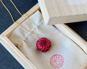 Temari ball pendant "Kiku" with red chrysanthemum flower, on gold filled chain necklace. Traditional Japanese jewelry, silk embroidery.