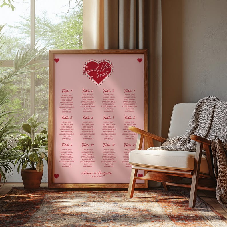 May include: A pink and red wedding seating chart with a heart-shaped design and the text "Saved You a Seat". The chart lists tables 1 through 12 with guest names and the date "12.18.2018".